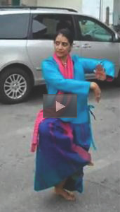 A woman stands dancing