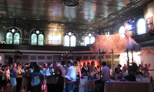 An overview of a dance hall with everyone visiting and having a great time